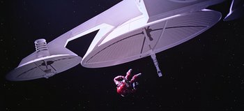 Movie still from “2001: A Space Odyssey” (1968), directed by Stanley Kubrick – A man in a spacesuit hanging upside down from a parachute; Extreme Wide shot, Overhead angle
