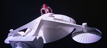 Movie still from “2001: A Space Odyssey” (1968), directed by Stanley Kubrick – A man in a spacesuit standing next to a space ship; Extreme Wide shot, Overhead angle