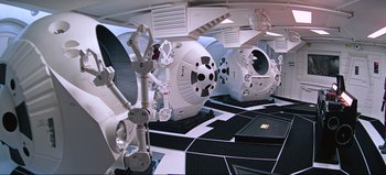 Movie still from “2001: A Space Odyssey” (1968), directed by Stanley Kubrick – A view of a room that looks like a space station; Extreme Wide shot, Overhead angle