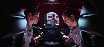 Movie still from “2001: A Space Odyssey” (1968), directed by Stanley Kubrick – Two men are looking at each other in a spaceship; Medium shot, Low angle