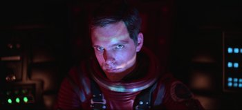 Movie still from “2001: A Space Odyssey” (1968), directed by Stanley Kubrick – A man in a red space suit is looking at the camera; Close Up shot, Low angle