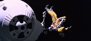 Movie still from “2001: A Space Odyssey” (1968), directed by Stanley Kubrick – An astronaut in a yellow space suit falling from a space ship; Wide shot, Overhead angle
