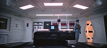 Movie still from “2001: A Space Odyssey” (1968), directed by Stanley Kubrick – A room filled with a lot of electronics and equipment; Wide shot, High angle