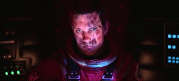 Movie still from “2001: A Space Odyssey” (1968), directed by Stanley Kubrick – A man in a red space suit is looking at the camera; Close Up shot, Overhead angle