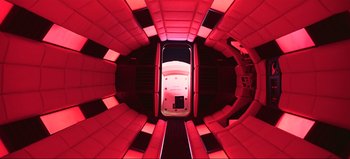 Movie still from “2001: A Space Odyssey” (1968), directed by Stanley Kubrick – Looking down at a room that has red lighting; Wide shot, Overhead angle