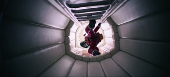 Movie still from “2001: A Space Odyssey” (1968), directed by Stanley Kubrick – A man in a helmet is hanging from a ladder; Wide shot, Overhead angle