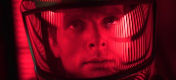 Movie still from “2001: A Space Odyssey” (1968), directed by Stanley Kubrick – A person looking at the camera; Close Up shot, Low angle