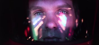 Movie still from “2001: A Space Odyssey” (1968), directed by Stanley Kubrick – A man's face with a light shining on his face; Extreme Close Up shot, Overhead angle