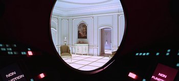 Movie still from “2001: A Space Odyssey” (1968), directed by Stanley Kubrick – A room with a round mirror in the center of the room; Wide shot, High angle