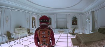 Movie still from “2001: A Space Odyssey” (1968), directed by Stanley Kubrick – An image of a person in a room with chairs; Wide shot, Over the shoulder angle