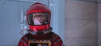 Movie still from “2001: A Space Odyssey” (1968), directed by Stanley Kubrick – A man in a red space suit and a helmet; Close Up shot, Low angle