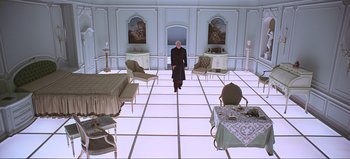 Movie still from “2001: A Space Odyssey” (1968), directed by Stanley Kubrick – An image of a man standing in the middle of a room; Wide shot, High angle