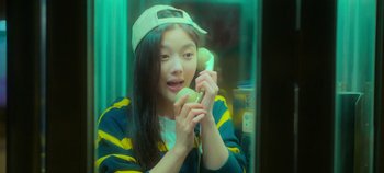 Movie still from “20th Century Girl” (2022), directed by Woo-ri Bang – A woman holding a phone up to her ear; Close Up shot, High angle