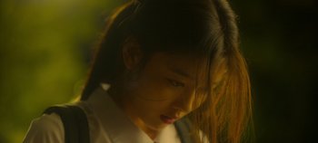 Movie still from “20th Century Girl” (2022), directed by Woo-ri Bang – A person wearing a white shirt; Close Up shot, Low angle