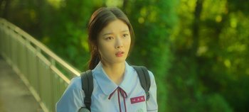 Movie still from “20th Century Girl” (2022), directed by Woo-ri Bang – A young woman in a white shirt with a backpack; Close Up shot, Over the shoulder angle