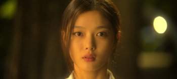 Movie still from “20th Century Girl” (2022), directed by Woo-ri Bang – A young woman with long brown hair is looking at the camera; Close Up shot, Low angle