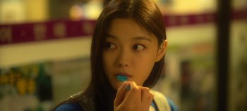 Movie still from “20th Century Girl” (2022), directed by Woo-ri Bang – A young girl brushing her teeth with an electric toothbrush; Close Up shot, Over the shoulder angle