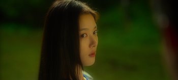 Movie still from “20th Century Girl” (2022), directed by Woo-ri Bang – A young woman is looking into the distance; Close Up shot, Low angle