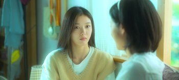Movie still from “20th Century Girl” (2022), directed by Woo-ri Bang – A young woman sitting in front of a mirror looking at another young woman; Close Up shot, Over the shoulder angle
