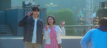 Movie still from “20th Century Girl” (2022), directed by Woo-ri Bang – A man and a woman standing next to each other; Medium shot, Low angle