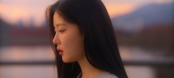 Movie still from “20th Century Girl” (2022), directed by Woo-ri Bang – A person with long black hair; Close Up shot, Over the shoulder angle