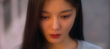 Movie still from “20th Century Girl” (2022), directed by Woo-ri Bang – A person with long hair; Close Up shot, Low angle