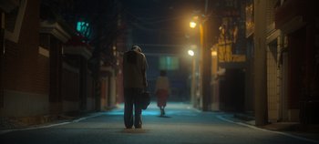 Movie still from “20th Century Girl” (2022), directed by Woo-ri Bang – A man and a woman walking down a street at night; Wide shot, Low angle