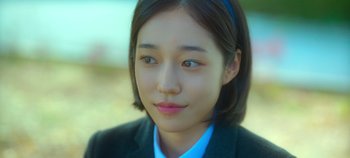 Movie still from “20th Century Girl” (2022), directed by Woo-ri Bang – A person wearing a suit; Close Up shot, High angle