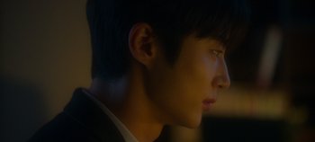 Movie still from “20th Century Girl” (2022), directed by Woo-ri Bang – A young man's face in the dark; Extreme Close Up shot, Over the shoulder angle
