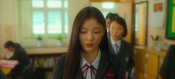 Movie still from “20th Century Girl” (2022), directed by Woo-ri Bang – A woman in a suit and tie standing in front of another woman; Close Up shot, Over the shoulder angle