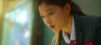 Movie still from “20th Century Girl” (2022), directed by Woo-ri Bang – A young asian girl looking at something in the distance; Close Up shot, Low angle