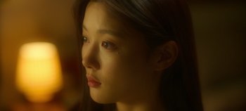 Movie still from “20th Century Girl” (2022), directed by Woo-ri Bang – A young woman's face in the dark; Close Up shot, High angle