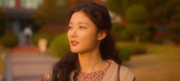 Movie still from “20th Century Girl” (2022), directed by Woo-ri Bang – A woman with long black hair is looking to her left; Close Up shot, Low angle