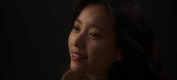 Movie still from “20th Century Girl” (2022), directed by Woo-ri Bang – A woman smiling for the camera; Close Up shot, High angle