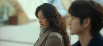 Movie still from “20th Century Girl” (2022), directed by Woo-ri Bang – A woman with long black hair wearing a jacket; Close Up shot, Over the shoulder angle