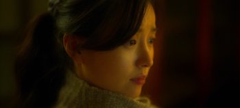 Movie still from “20th Century Girl” (2022), directed by Woo-ri Bang – A person looking at the camera; Close Up shot, Over the shoulder angle