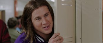 Movie still from “22 Jump Street” (2014), directed by Phil Lord – A young man holding onto a cabinet door; Close Up shot, Over the shoulder angle