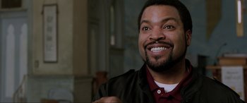 Movie still from “22 Jump Street” (2014), directed by Phil Lord – A person with a beard smiling; Close Up shot, Over the shoulder angle