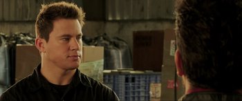 Movie still from “22 Jump Street” (2014), directed by Phil Lord – A man standing in front of boxes in a warehouse; Close Up shot, Over the shoulder angle