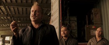 Movie still from “22 Jump Street” (2014), directed by Phil Lord – Two men standing next to each other in front of a building; Medium shot, Low angle