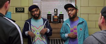 Movie still from “22 Jump Street” (2014), directed by Phil Lord – A couple of men standing next to each other in a room; Medium shot, Overhead angle