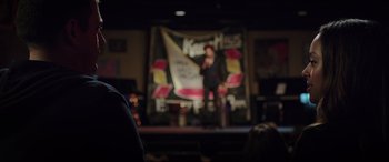 Movie still from “22 Jump Street” (2014), directed by Phil Lord – A man standing on a stage in front of an audience; Medium shot, Over the shoulder angle