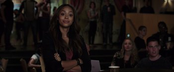 Movie still from “22 Jump Street” (2014), directed by Phil Lord – A woman standing in front of a group of people; Close Up shot, Over the shoulder angle