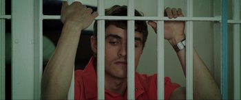 Movie still from “22 Jump Street” (2014), directed by Phil Lord – A man in a red shirt behind a white fence; Close Up shot, High angle