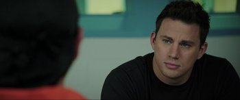 Movie still from “22 Jump Street” (2014), directed by Phil Lord – A person sitting in front of another person; Close Up shot, Over the shoulder angle