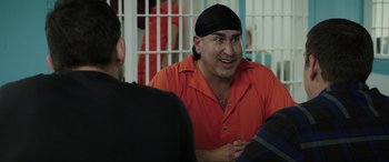 Movie still from “22 Jump Street” (2014), directed by Phil Lord – A man in a red shirt is talking to another man in a prison cell; Close Up shot, Over the shoulder angle