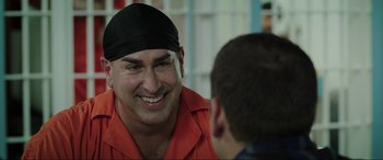 Movie still from “22 Jump Street” (2014), directed by Phil Lord – A man wearing an orange shirt talking to another man wearing a black hat; Close Up shot, Over the shoulder angle