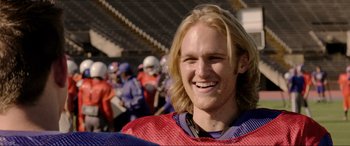 Movie still from “22 Jump Street” (2014), directed by Phil Lord – A person wearing a football uniform; Close Up shot, Over the shoulder angle