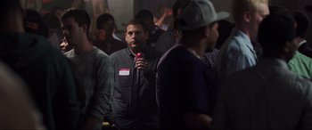 Movie still from “22 Jump Street” (2014), directed by Phil Lord – A group of people standing in a room; Medium shot, Over the shoulder angle