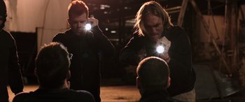 Movie still from “22 Jump Street” (2014), directed by Phil Lord – Two men are holding their phones up to their ears; Medium shot, Over the shoulder angle